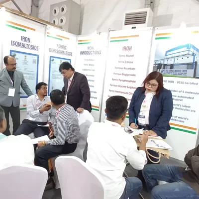 A group of people sitting around a table at a show registration.